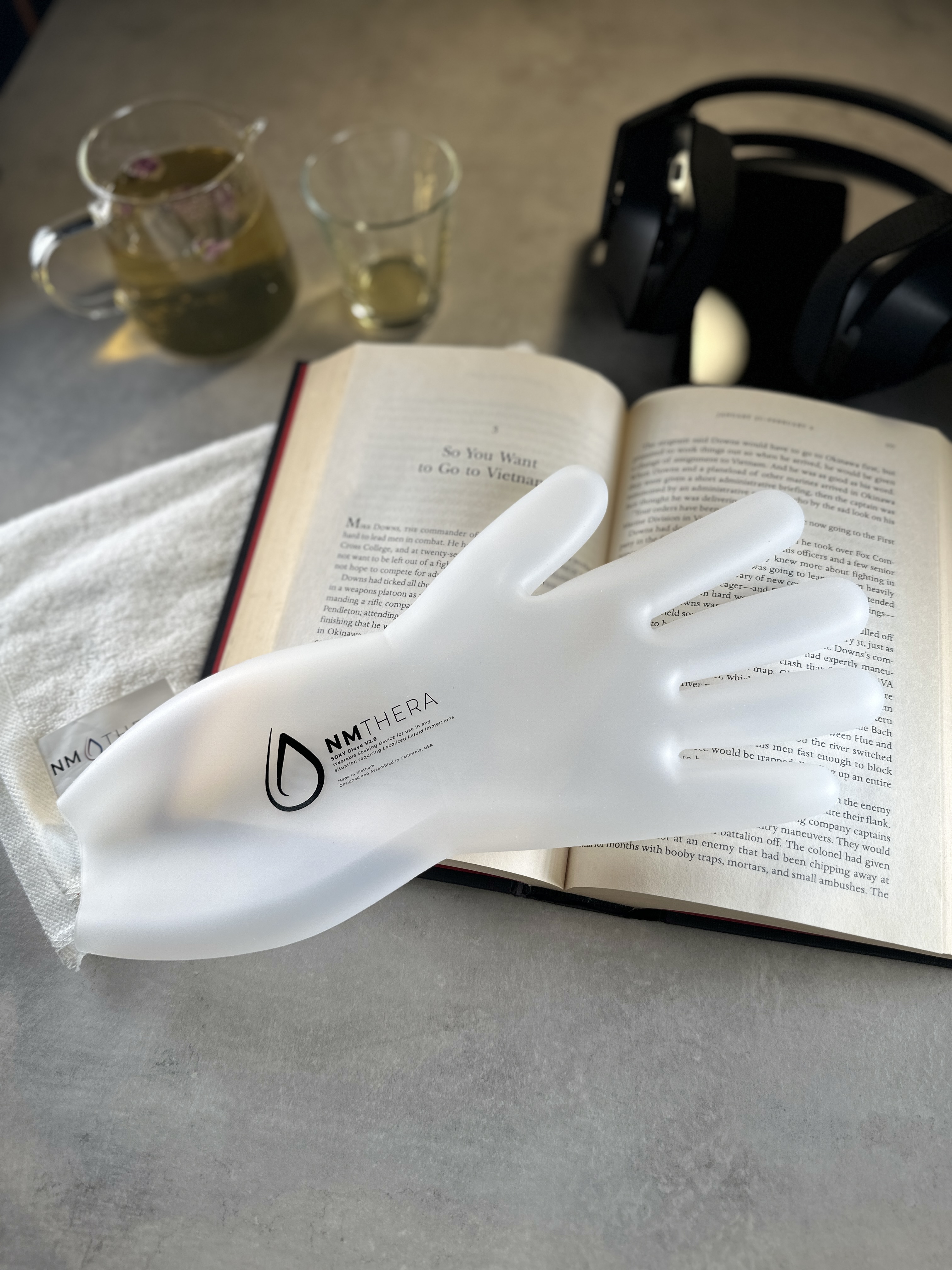 SOKY resting on a book — ready for a quiet soak session